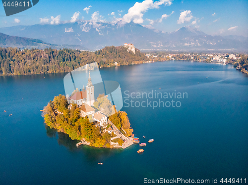 Image of Aerial view of Bled island on lake Bled, and Bled castle and mountains in background, Slovenia.