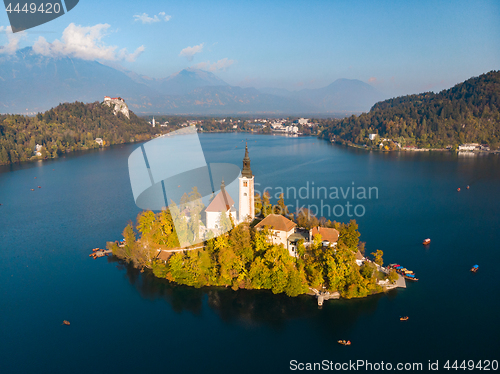 Image of Aerial view of Bled island on lake Bled, and Bled castle and mountains in background, Slovenia.