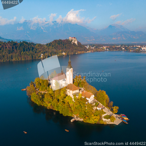 Image of Aerial view of Bled island on lake Bled, and Bled castle and mountains in background, Slovenia.