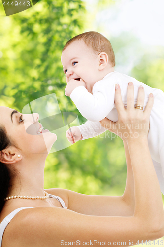 Image of mother with baby over green natural background