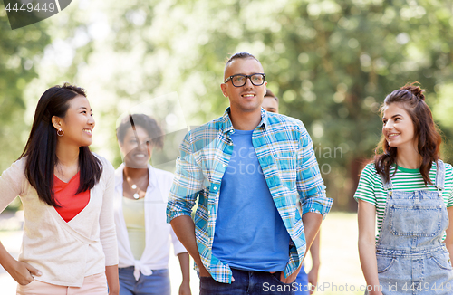 Image of group of happy international friends in park