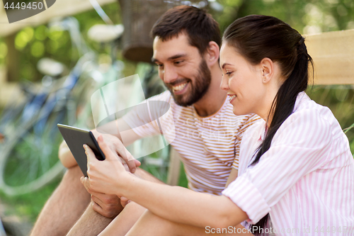 Image of couple with tablet pc and bicycles at summer park