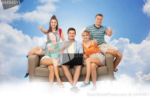 Image of friends with laptop sit on sofa and show thumbs up