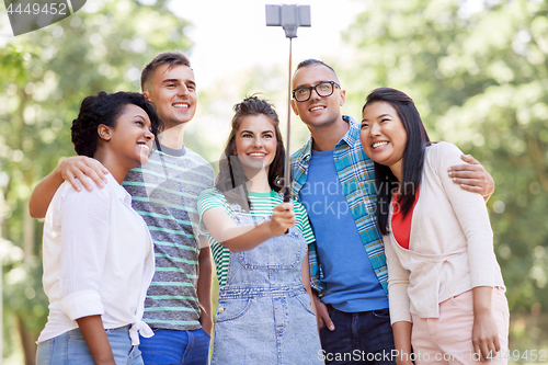 Image of international friends taking selfie in park