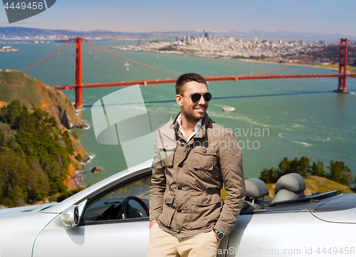 Image of man at convertible car over golden gate bridge