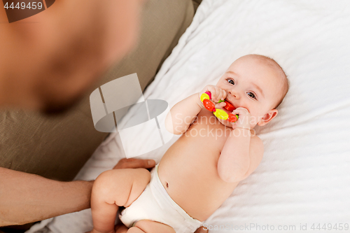 Image of close up of father and baby with rattle