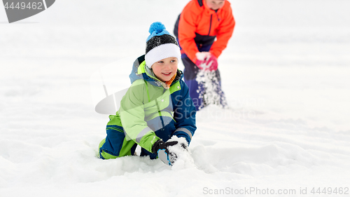 Image of happy little kids playing outdoors in winter