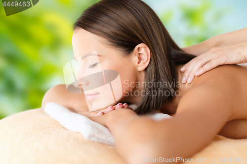 Image of close up of beautiful woman having massage at spa