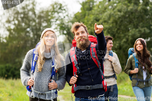 Image of friends or travelers with backpacks hiking