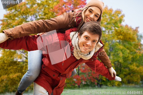 Image of happy young couple having fun in autumn park