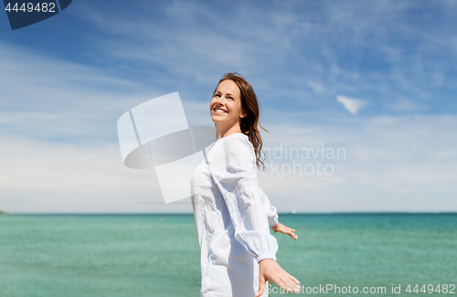 Image of happy smiling woman on summer beach