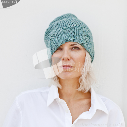 Image of Woman in warm turquoise beanie wool knitted hat.