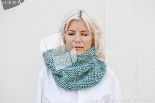 Image of Woman in warm turquoise green wool knitted snood.