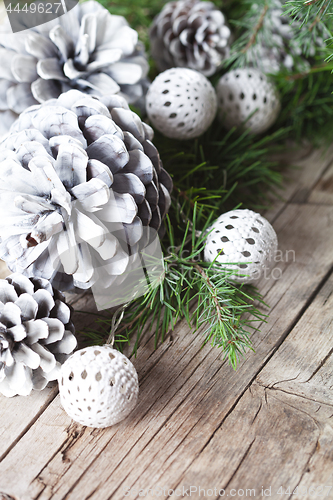 Image of Evergreen fir tree branch, white pine cones and balls.