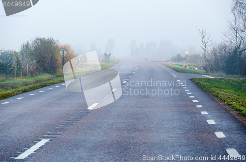 Image of Foggy road by morning sunshine