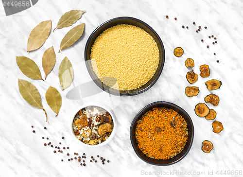 Image of Couscous and cooking ingredients on marble background