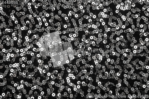 Image of Shiny silver sequins on black background