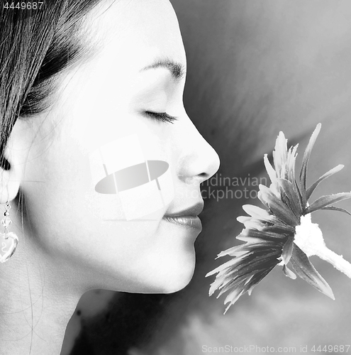 Image of Relaxed Calm Girl Smelling A Big Flower