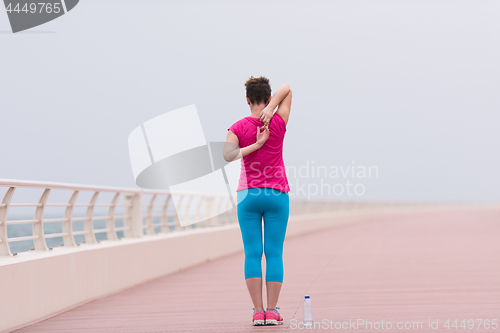 Image of woman stretching and warming up on the promenade