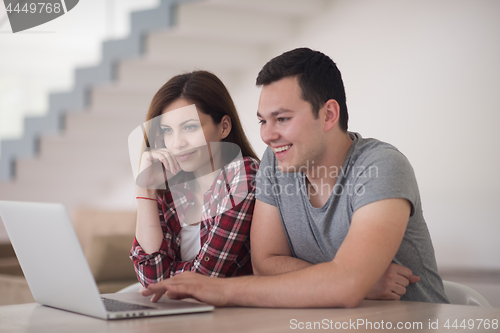 Image of happy young couple buying online