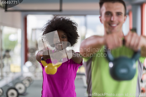 Image of couple  workout with weights at  crossfit gym