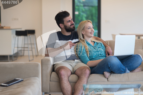 Image of young happy couple relaxes in the living room