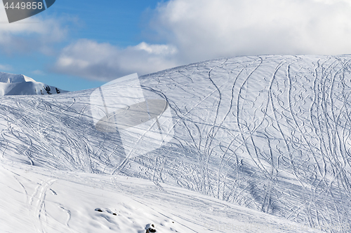 Image of Slope for freeriding with traces from skis, snowboards and blue 