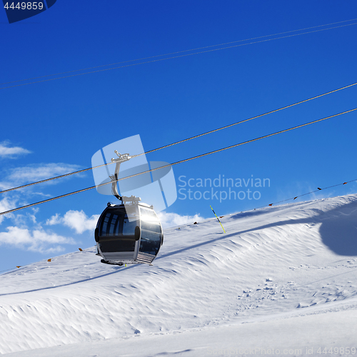 Image of Gondola lift on ski resort at sun wind day