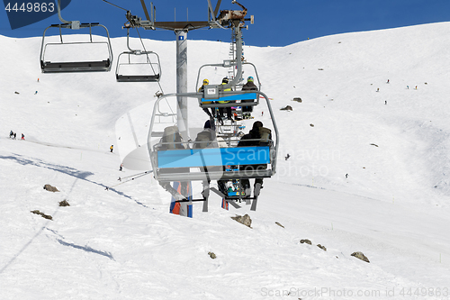 Image of Skiers and snowboarders on chair-lift