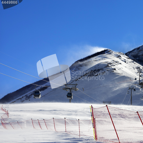 Image of Gondola lift on ski resort at windy winter day