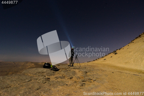 Image of Light beam into the night desert