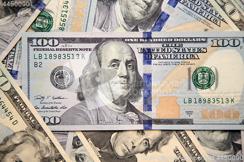 Image of Close up of new hundred dollar bill with portrait of Franklin