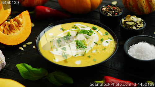 Image of Pumpkin soup in bowl sprinkled with herbs