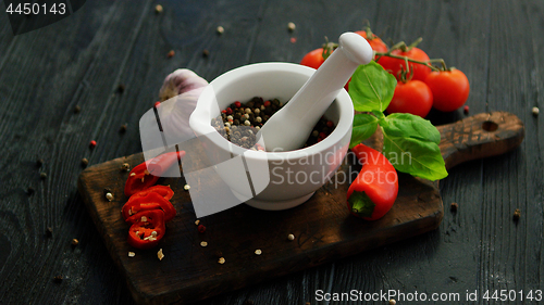 Image of Bowl with spices on wooden cutting board