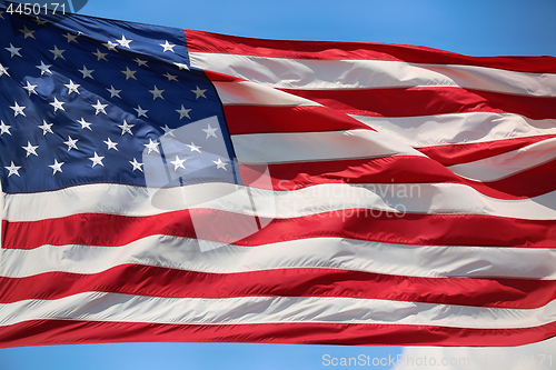 Image of Waving star and striped American flag, USA