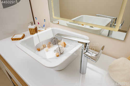 Image of Bathroom interior detail with sink and faucet