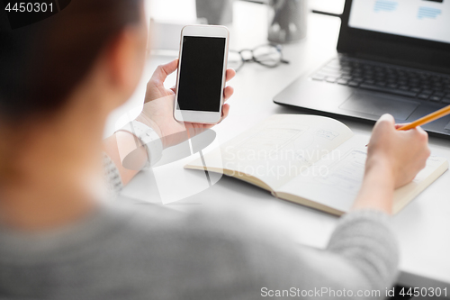 Image of web designer working on smartphone user interface