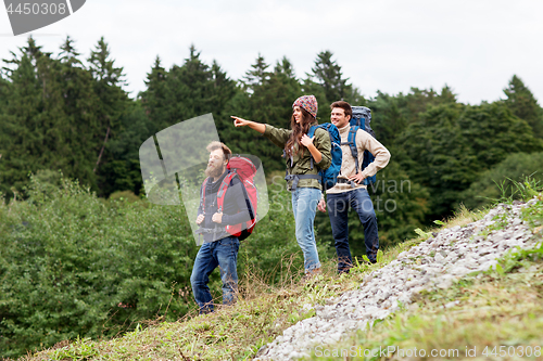 Image of friends or travelers with backpacks hiking