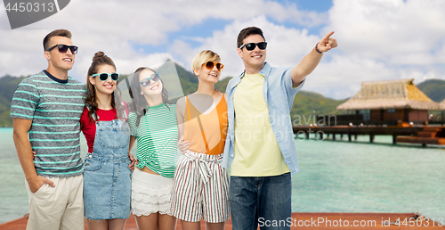 Image of friends in sunglasses over bora bora background