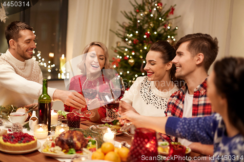 Image of friends celebrating christmas and drinking wine