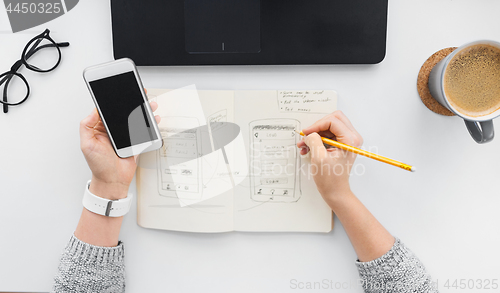 Image of web designer working on smartphone user interface