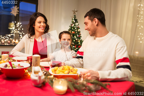 Image of happy family having christmas dinner at home