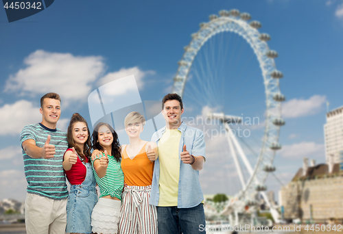 Image of friends showing thumbs up over ferry wheel