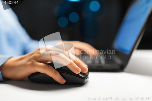 Image of close up of female hand using computer mouse