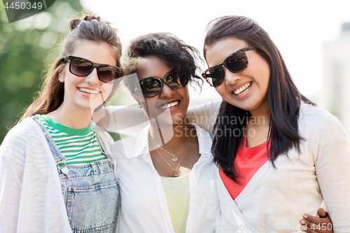 Image of happy young women in sunglasses outdoors