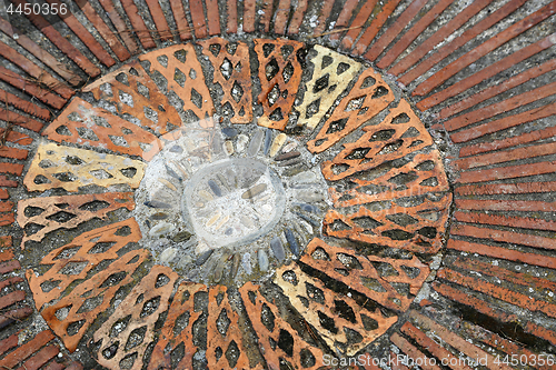 Image of Cobble round mosaic. Patterned floor walkway in the park.