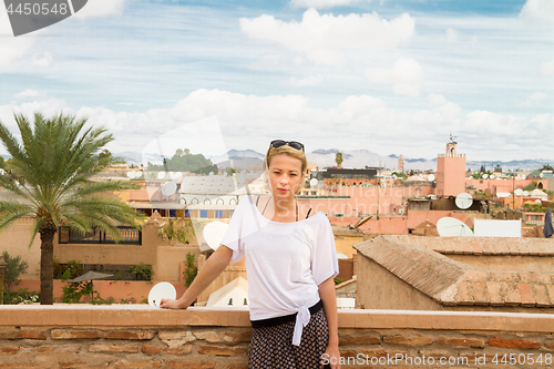 Image of Woman admiring traditional moroccan architecture in one of the palaces in medina of Marrakesh, Morocco.