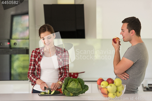 Image of Young handsome couple in the kitchen