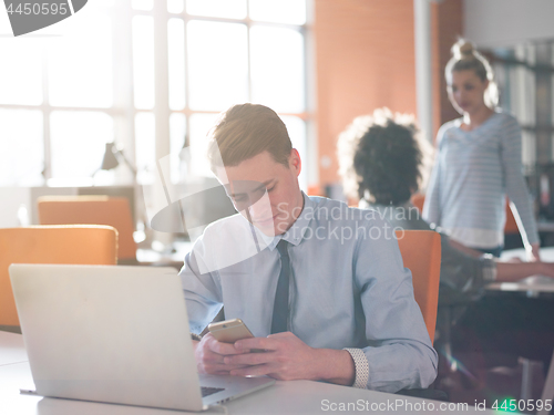 Image of businessman working using a laptop in startup office