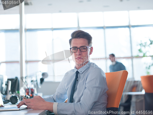 Image of businessman working using a laptop in startup office